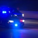 Police car with flashing lights on highway