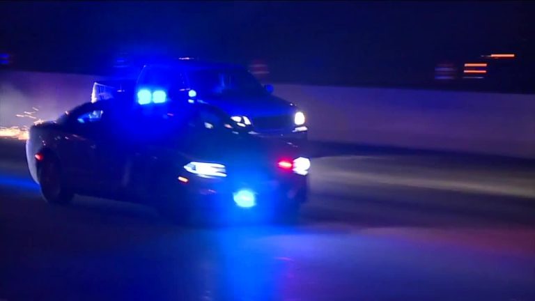 Police car with flashing lights on highway