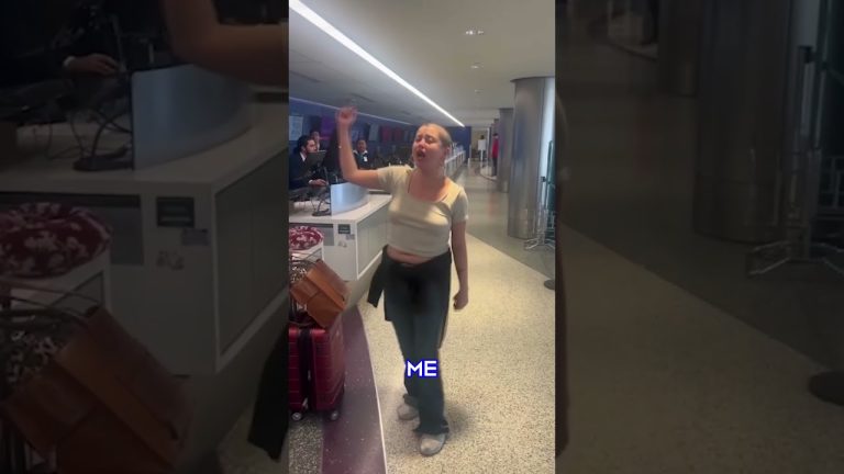 Person raising hand at airport counter.