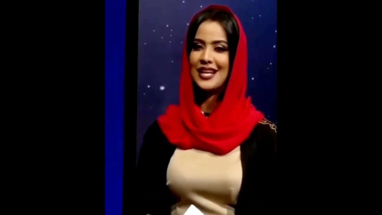 Woman in red scarf on TV set