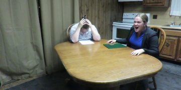 Two people arguing at a kitchen table