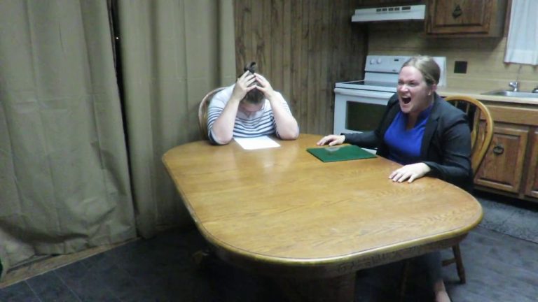 Two people arguing at a kitchen table