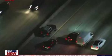 Aerial view of cars on highway at night.