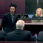 Courtroom scene with judge and defendant standing.