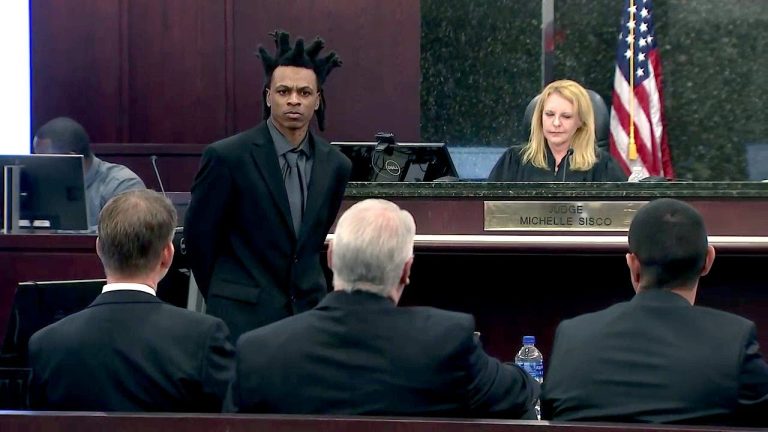 Courtroom scene with judge and defendant standing.