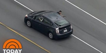 Highway police chase captured from above.