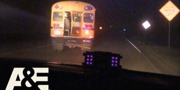 School bus driving at night on rural road.