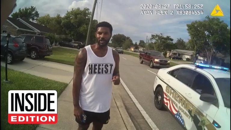 Man standing near police car on street