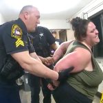 Police officer handcuffing person during arrest