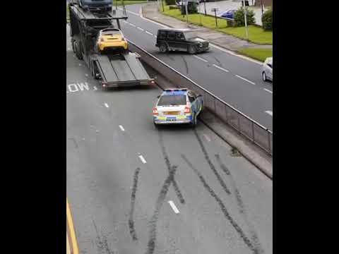 Police car and truck on roadside with tire marks.