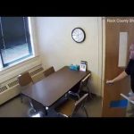 Man enters office with table and chairs.