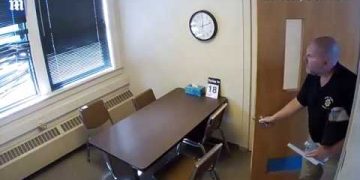 Man enters office with table and chairs.