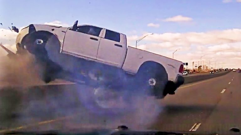 Pickup truck airborne on highway accident scene.