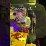 Waitress with tablet beside burger and fries on table