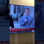 Reporter discussing Michigan heat wave on street