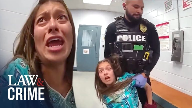 Police officer detaining a woman in distress.