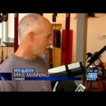 Man interviewed in fitness studio setting.