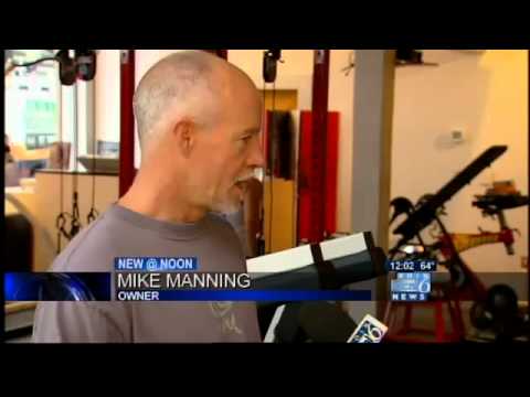 Man interviewed in fitness studio setting.