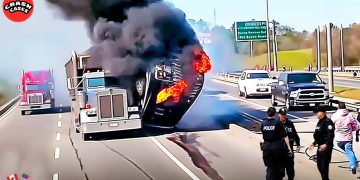 Truck fire on highway with police officers nearby