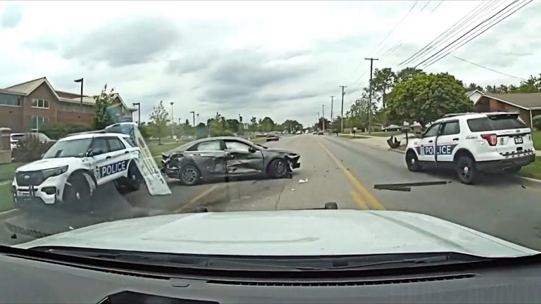 Police cars at crash scene on road