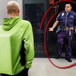 Man in green hoodie faces confused security guard.