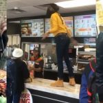 People arguing at fast food counter.