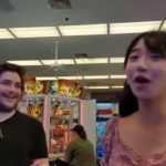 Two people enjoying arcade games indoors.