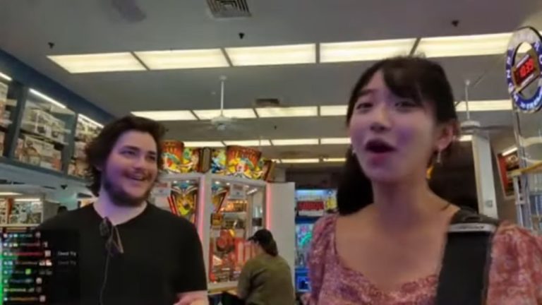 Two people enjoying arcade games indoors.