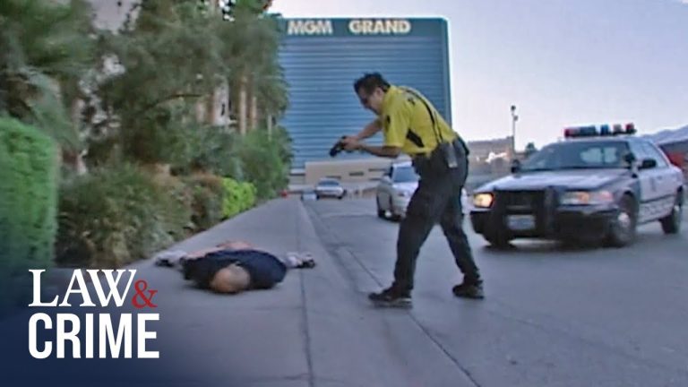 Police photographing crime scene on sidewalk near hotel.