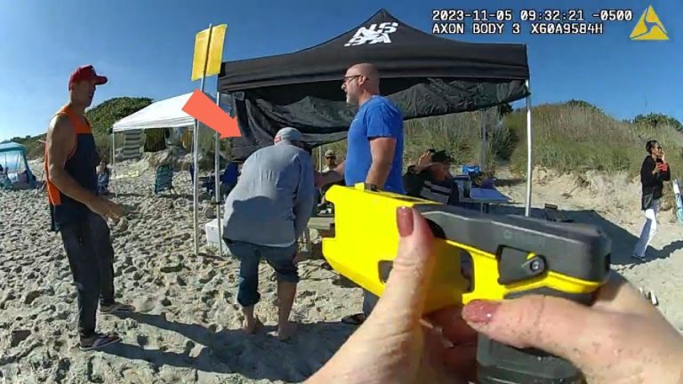 People on beach under tents with equipment.