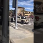 Pickup truck with missing door at intersection.