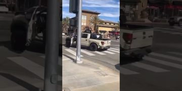 Pickup truck with missing door at intersection.