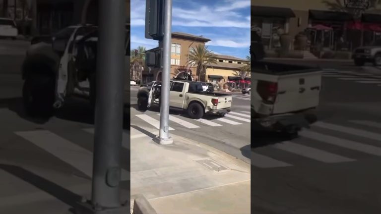 Pickup truck with missing door at intersection.