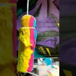 Colorful paint dripping on sponge cylinder.