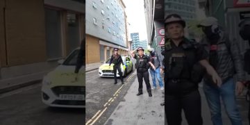 Police officers and car on urban street