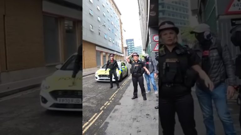 Police officers and car on urban street