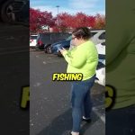 Person in parking lot with phone, fishing shirt