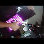 Person playing keyboard like a guitar with lights