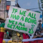 Protest sign promoting peace with humor.