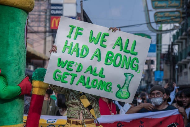 Protest sign promoting peace with humor.