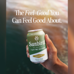 Hand holding Sunbird Pineapple THC Seltzer can.