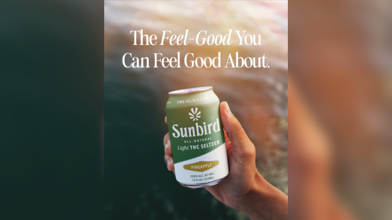 Hand holding Sunbird Pineapple THC Seltzer can.