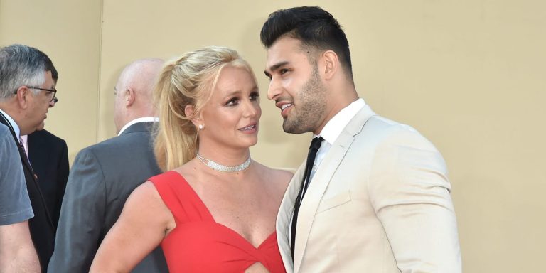 Couple in formal attire smiling at an event.