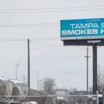 Billboard reads 'Tampa Bay Smokes Hemp' near highway.