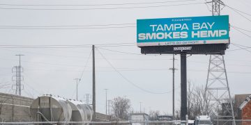 Billboard reads 'Tampa Bay Smokes Hemp' near highway.