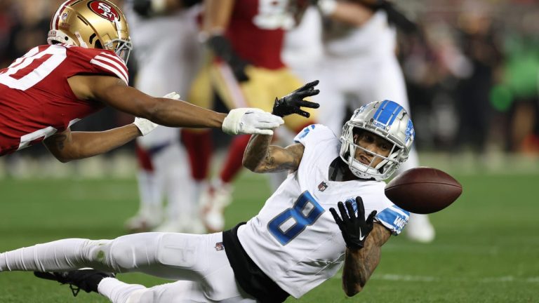 Football game action, players competing for ball.