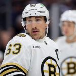 Hockey player on ice in Boston Bruins jersey.