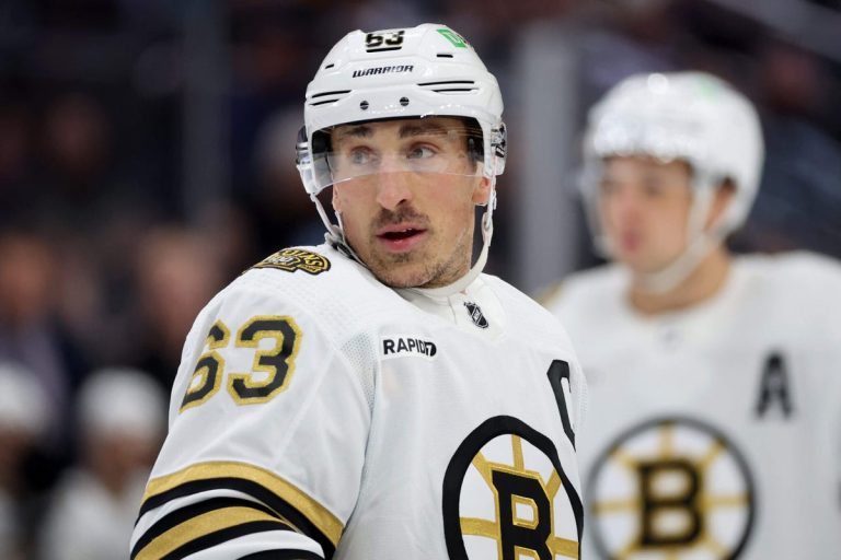 Hockey player on ice in Boston Bruins jersey.