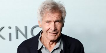 Smiling elderly man with gray hair in suit