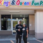 Entrance of Kings & Queens Fun Place with people.